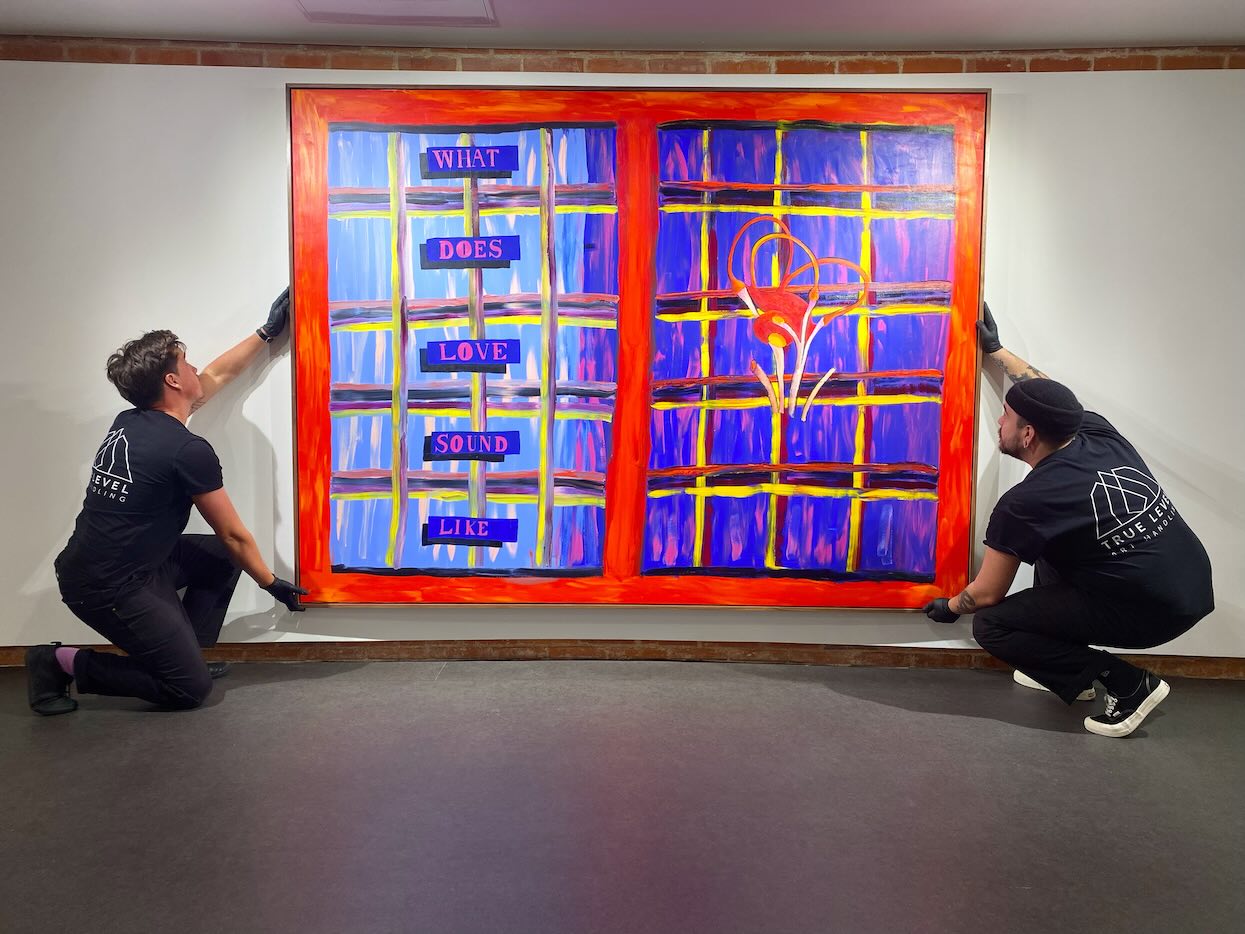 True Level technicians installing artwork