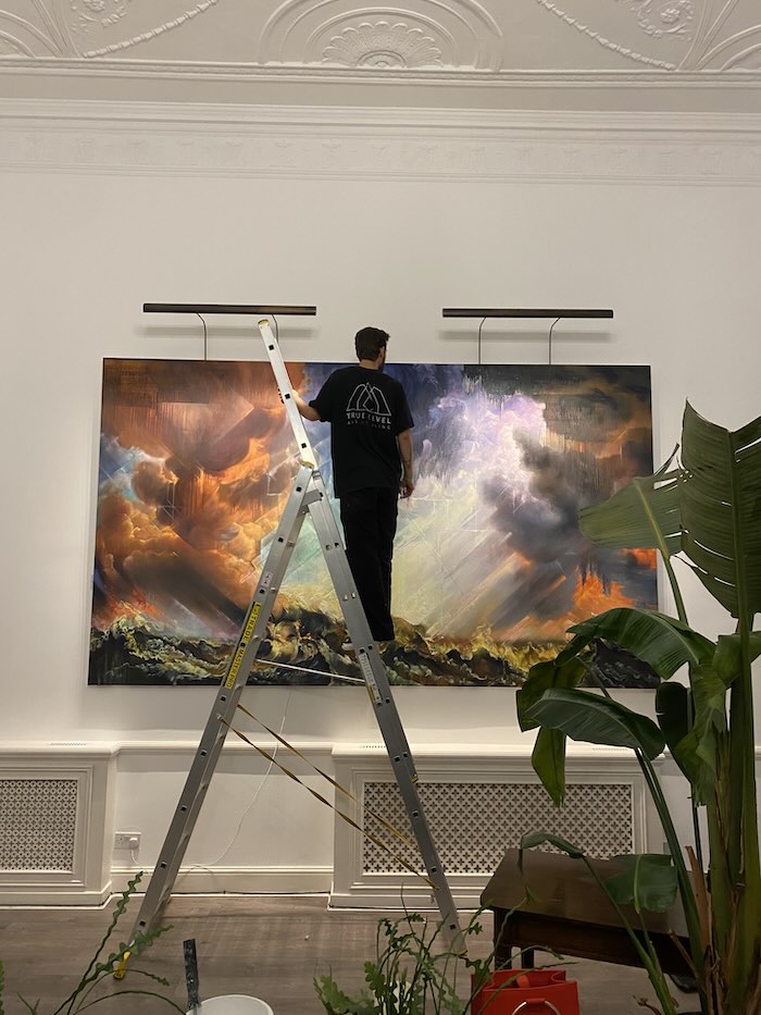 A large piece of artwork being installed by a True Level technician