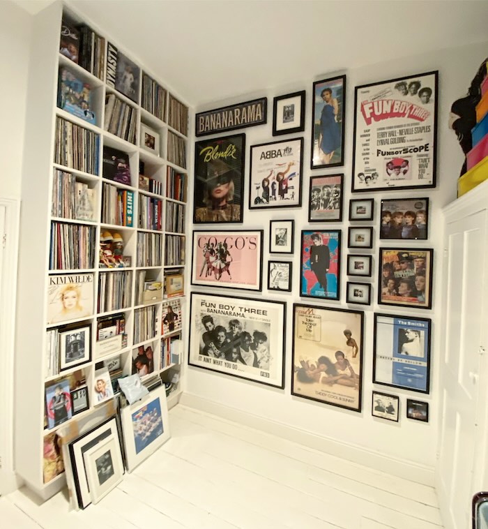 A variety of artwork expertly hung alongside a bookcase